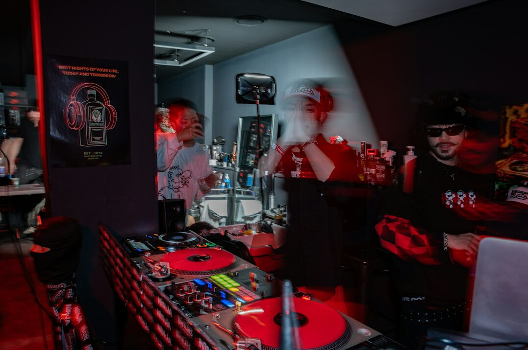 Broadcast control room with technicians monitoring live video feeds on multiple screens